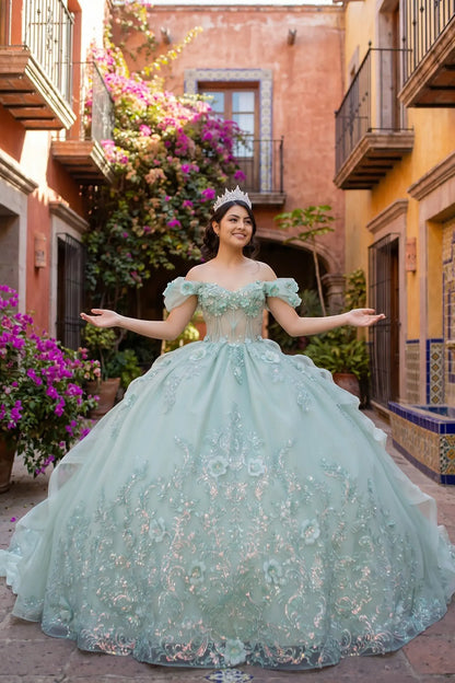 Woman in a sage quince ball gown with off the shoulder sleeves