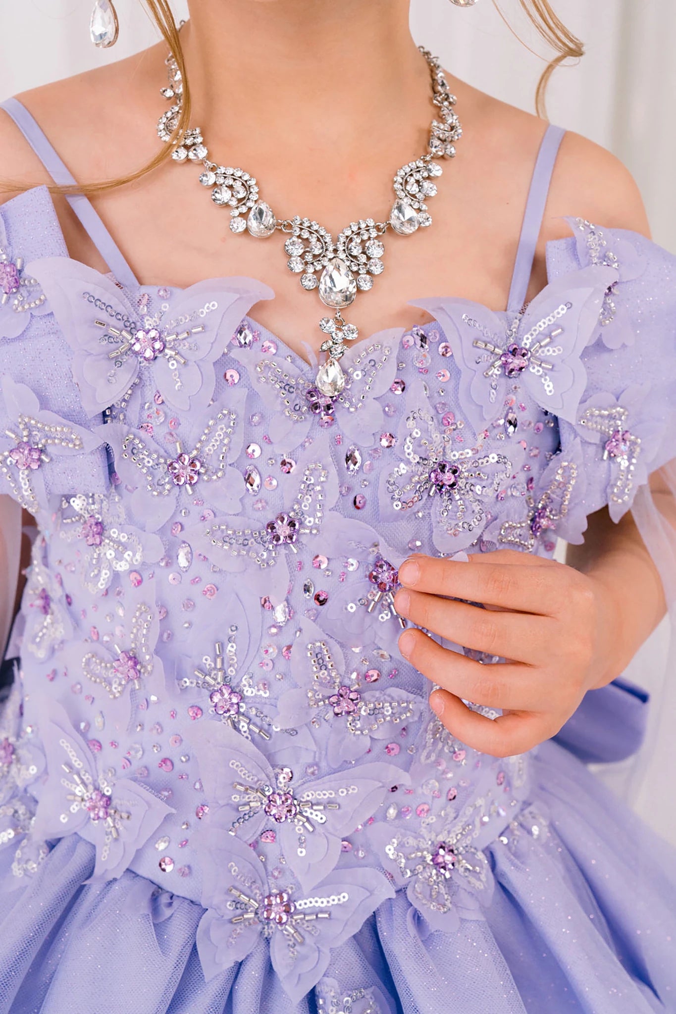 Lilac detail zoom kids mini quinceañera mini quince dress with glitter puff sleeves, butterfly applique and necklace.