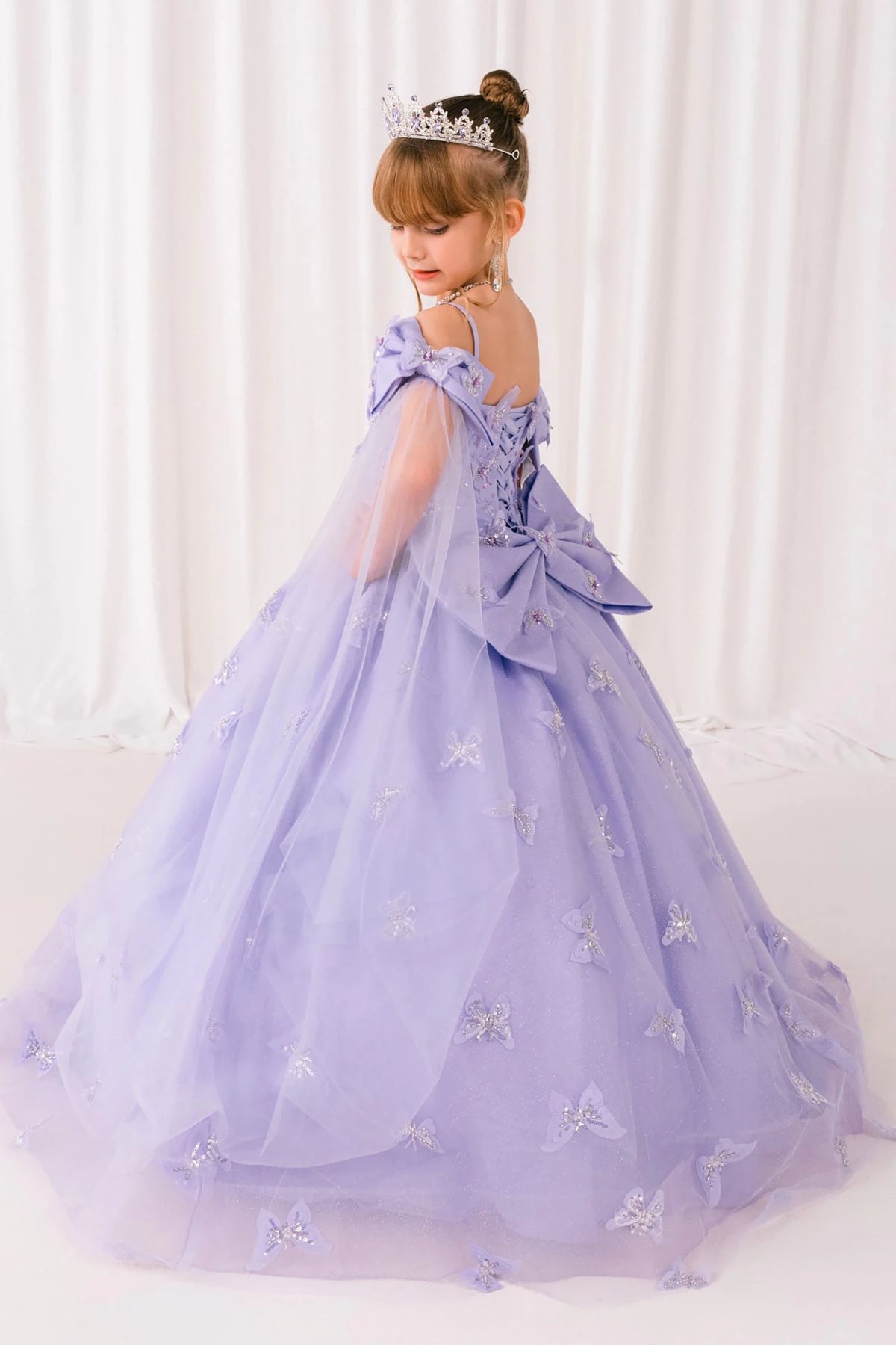 Lilac front view kids mini quinceañera mini quince dress with glitter puff sleeves and sheer train.