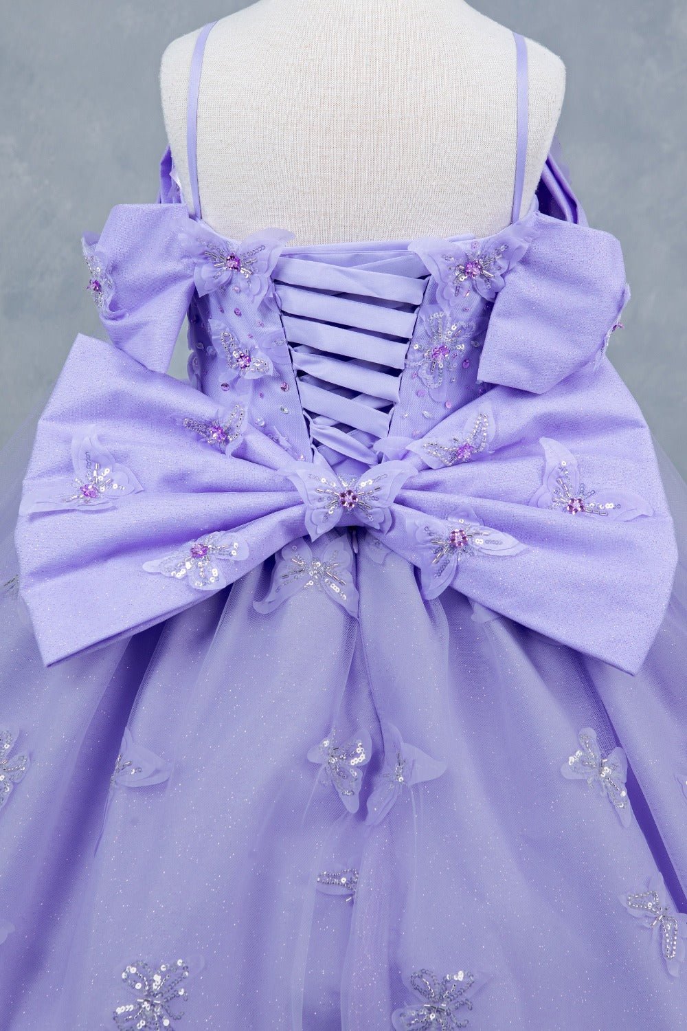 Lilac back zoom kids mini quinceañera mini quince dress with glitter puff sleeves, butterfly applique.