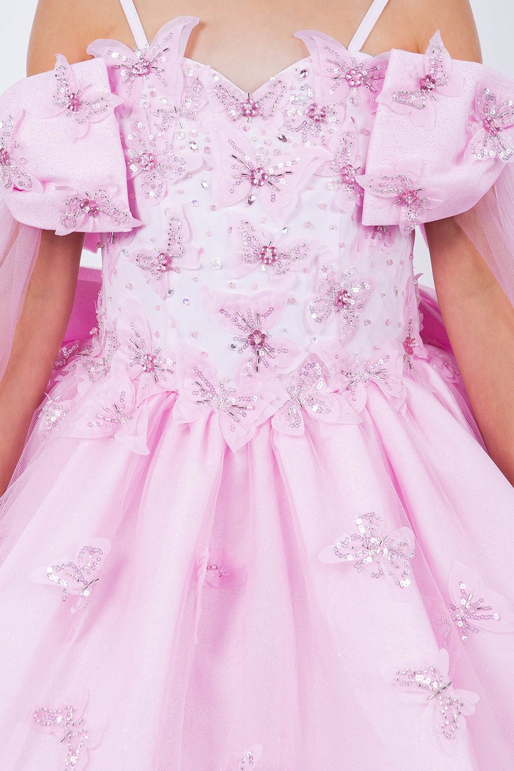 Pink front zoom kids mini quinceañera mini quince dress with glitter puff sleeves, butterfly applique and bow sleeves.