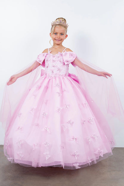 Young girl in a pink mini quince princess dress with a tiara on a plain background
