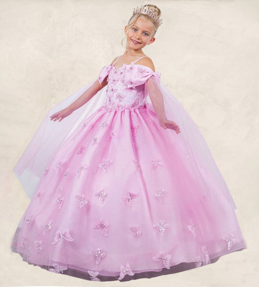 Young girl in a pink princess dress with a tiara on a beige background