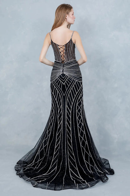 A full back view of a woman wearing a black mermaid dress with a lace-up corset and tulle flare.