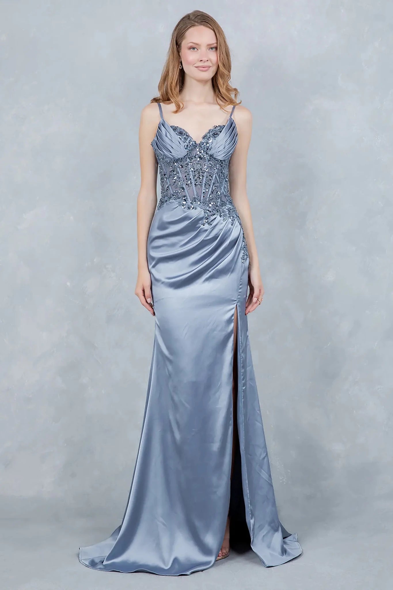 A full-length front view of a woman wearing a blue satin prom dress highlighting its elegant silhouette.