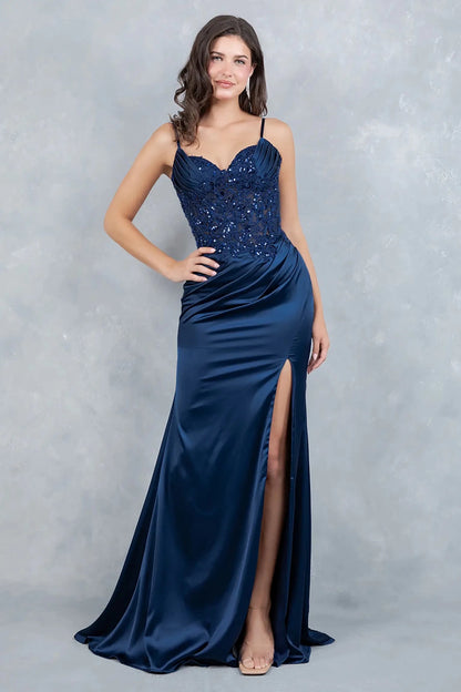 Full front view of a women wearing navy satin corset prom dress with lace appliqués and slit.
