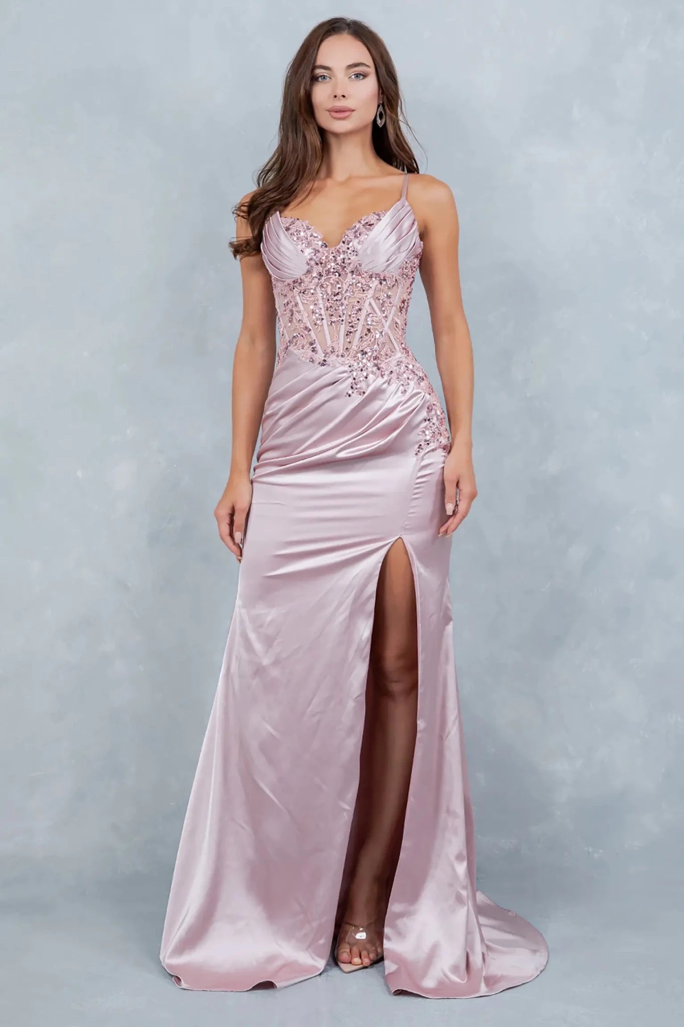 A full-length view of a woman wearing rose gold satin prom dress with a graceful silhouette.