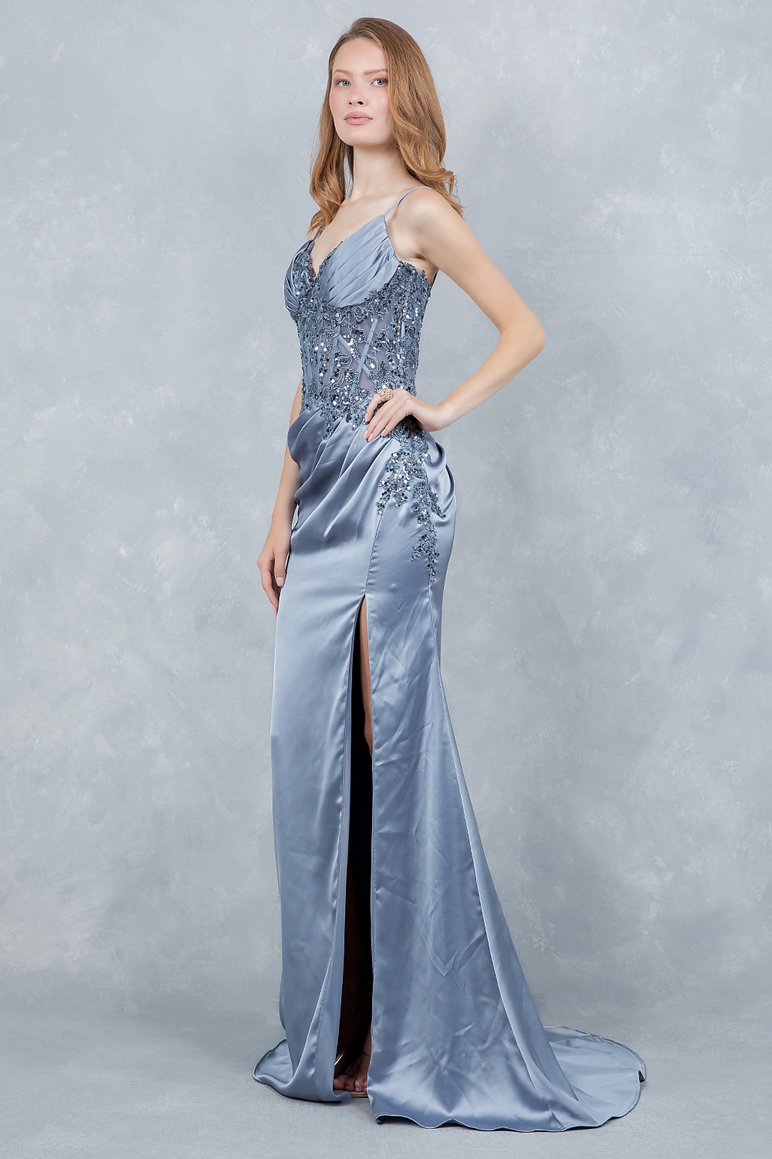 Dusty blue prom dress completed with thigh-high slit and sleek finish