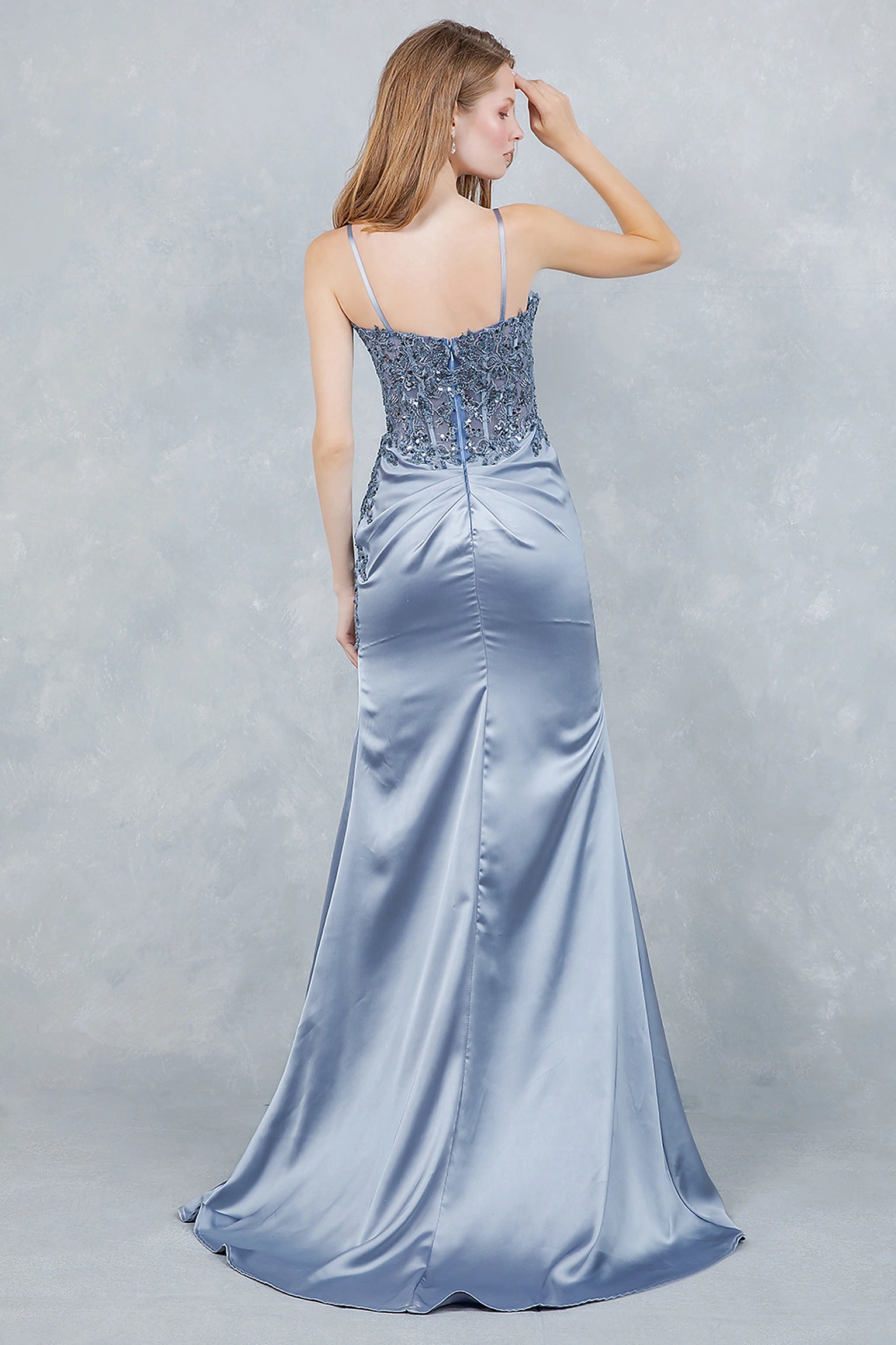 Dusty blue prom dress designed with open back and zipper closure