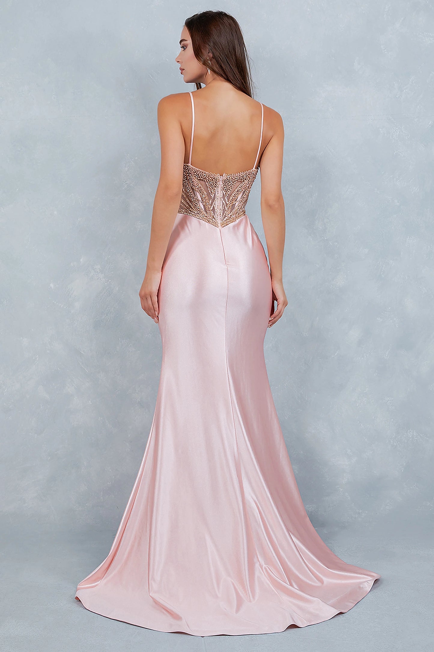 Blush satin mermaid prom dress designed with sheer beaded back and zipper closure