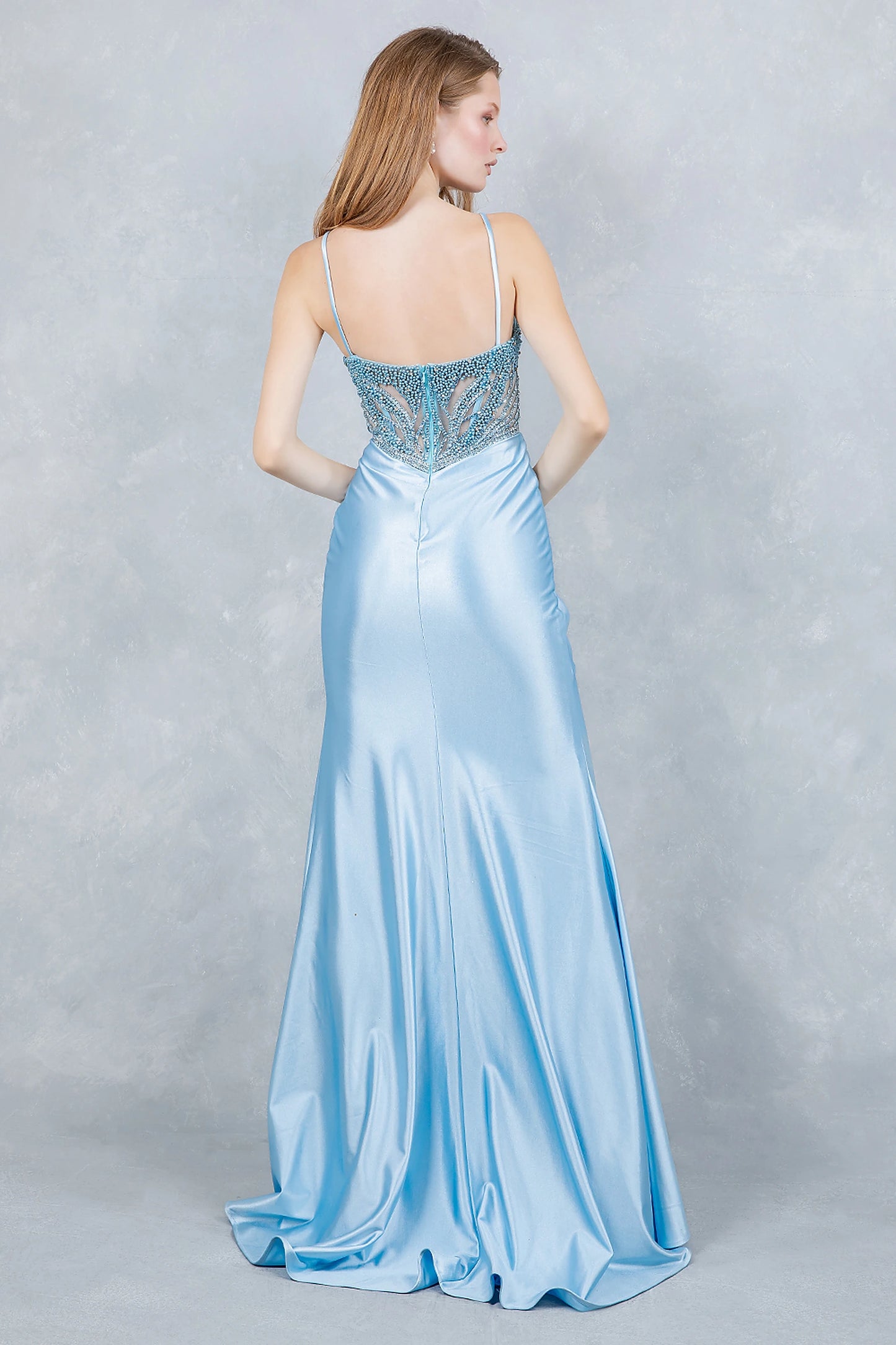 Dusty Blue prom dress designed with sheer beaded back and zipper closure