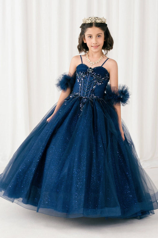 Shown in a front view, the Navy mini quince dress has thin straps, sheer puff sleeves and a full glitter skirt.