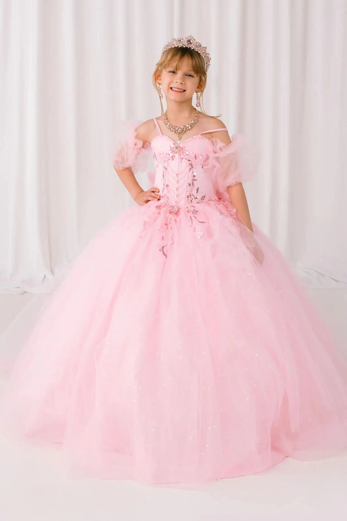 Front view of burgundy mini quinceañera mini quince dress with beaded bodice, floral appliqué, draped details, sparkling tulle skirt, and matching tulle arm cuffs.
