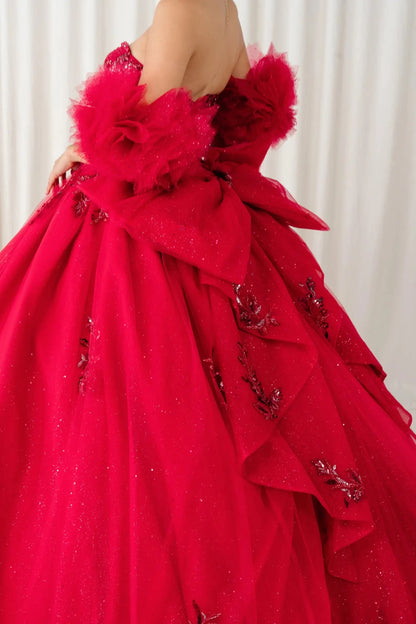 Side detail close-up view – Close-up side detail of red quinceañera ball gown showing feathered sleeves, glitter tulle, and floral embroidery.