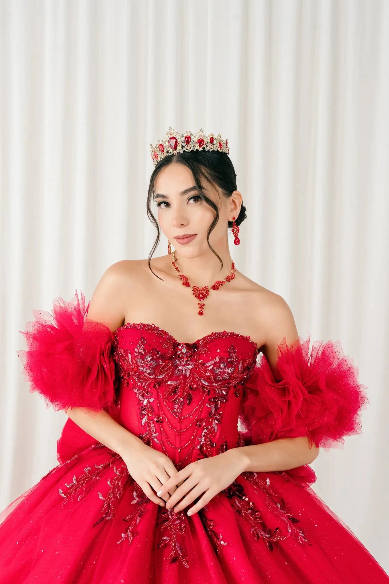 Three-quarter side view – Side angle of red quinceañera ball gown showing voluminous skirt, floral appliqués, and elegant silhouette.