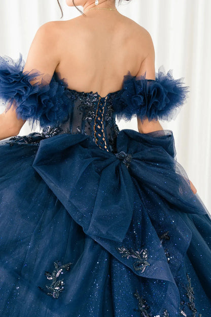 Back detail view of navy blue ball gown showing lace-up corset back and oversized bow
