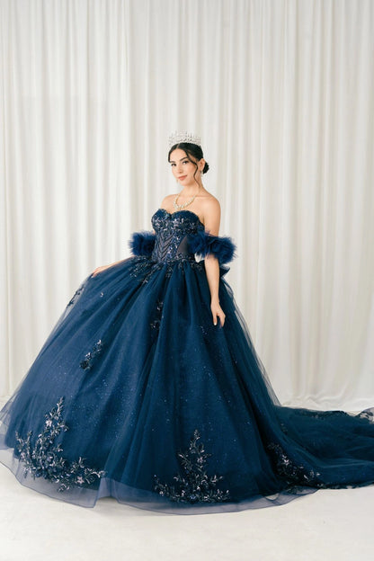 Shown in a front view, the Navy quinceañera dress has beaded bodice and sheer puff sleeves above a full glitter skirt.