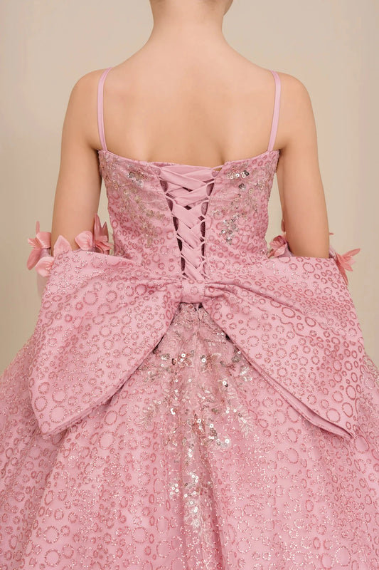 Back close up view of Dusty Rose mini quince ball gown with glitter floral embroidered bodice, full skirt, lace up back, oversized bow detail