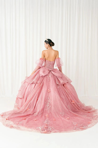 Back full-length view of Dusty Rose quinceañera ball gown with off shoulder tulle sleeves, sweetheart sequin bodice, layered glitter tulle skirt, and cathedral train
