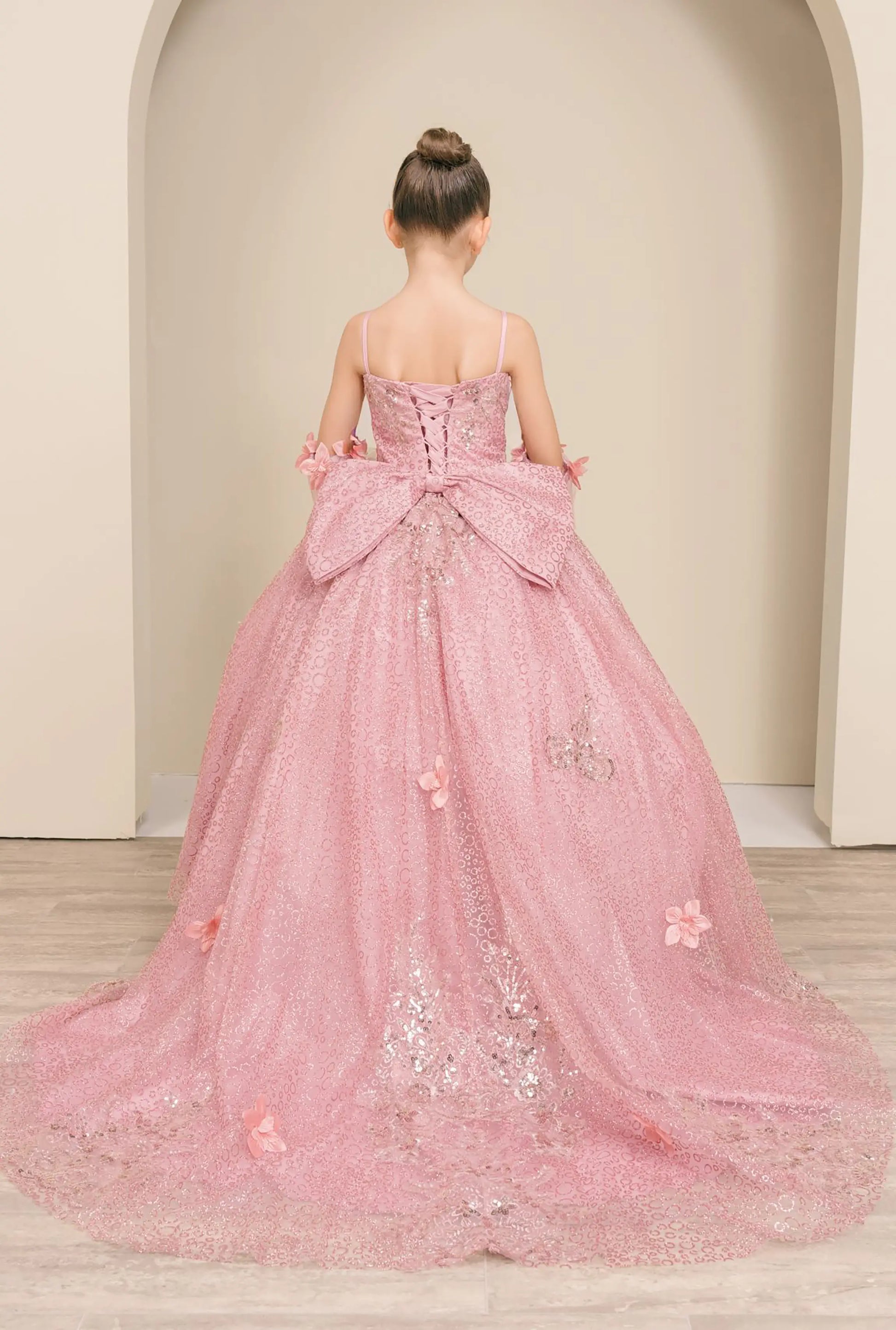 Black full-length view of Dusty Rose mini quince ball gown with glitter floral embroidered bodice, full skirt, lace up back, oversized bow, and sheer lace gloves