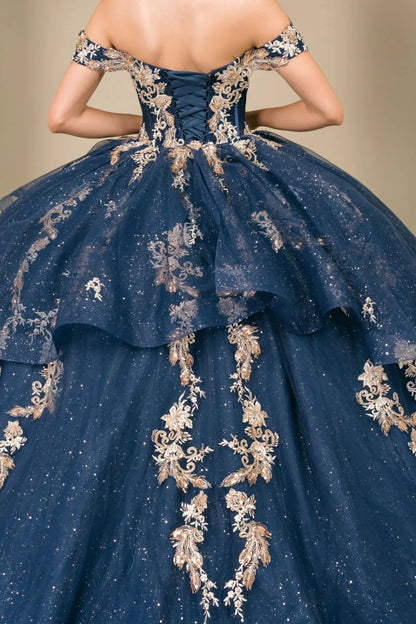 Close-up of woman back-facing in navy quinceañera dress with lace-up corset bodice, gold embroidery, detachable cape layer, and extended train detail