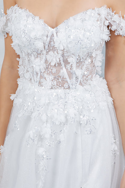 Close-up of a white wedding dress with floral embellishments