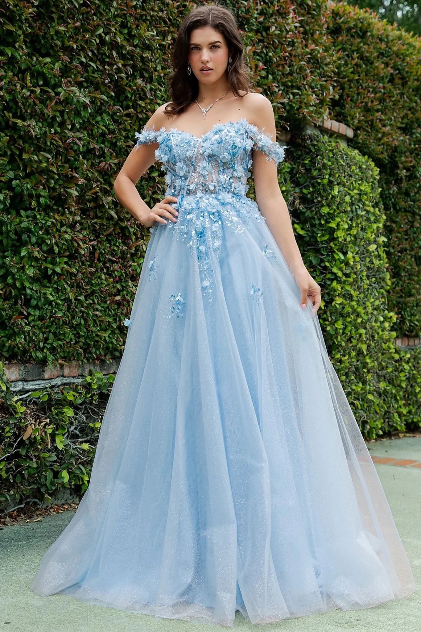 Blue prom dress designed with 3d floral appliques for soft movement to flowing silhouette