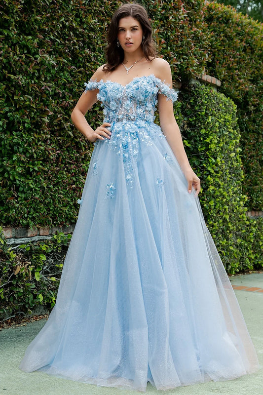 Blue prom dress designed with 3d floral appliques for soft movement to flowing silhouette