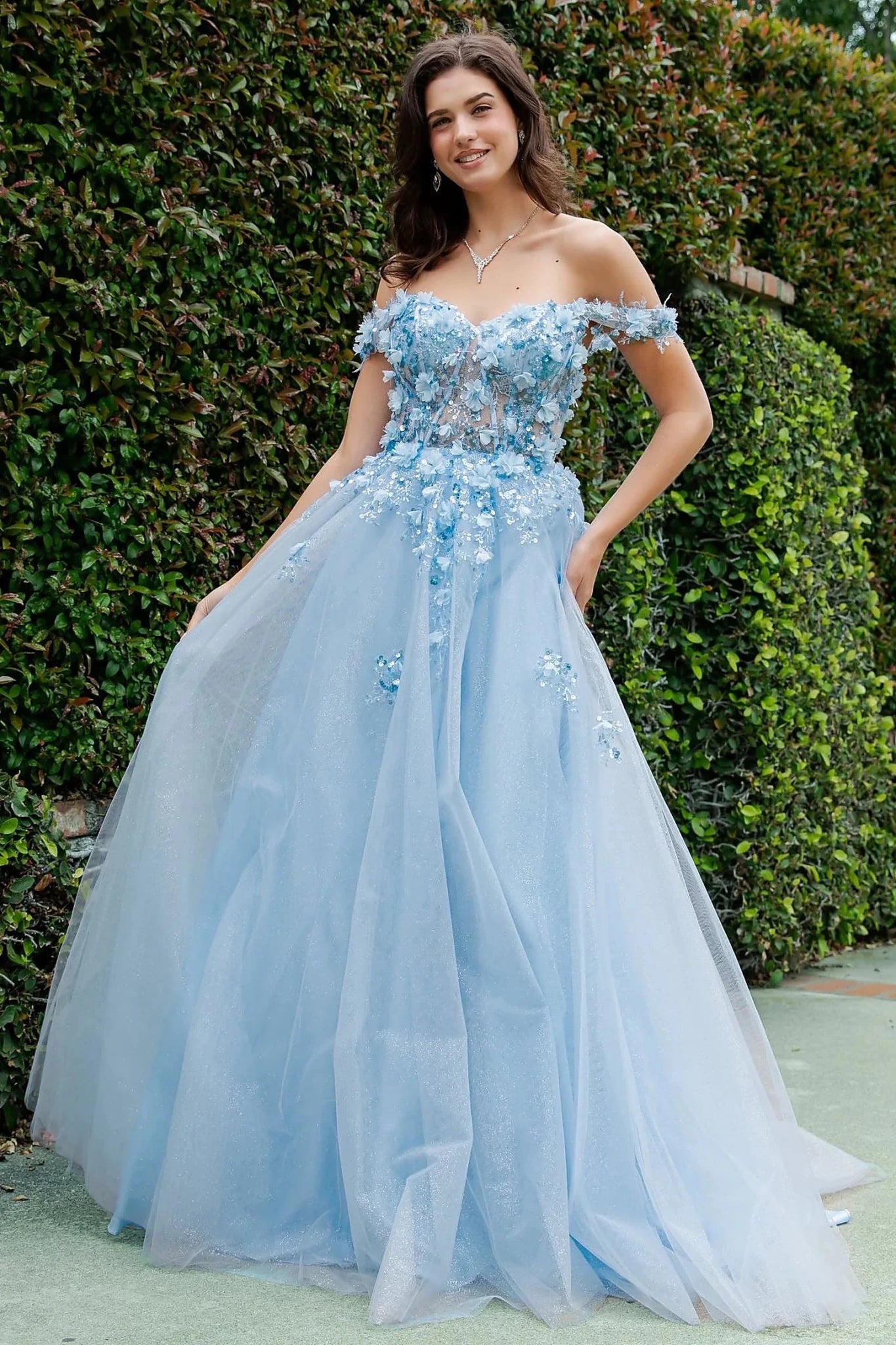 Blue prom dress designed with florals embroidery adding soft movement to flowing silhouette