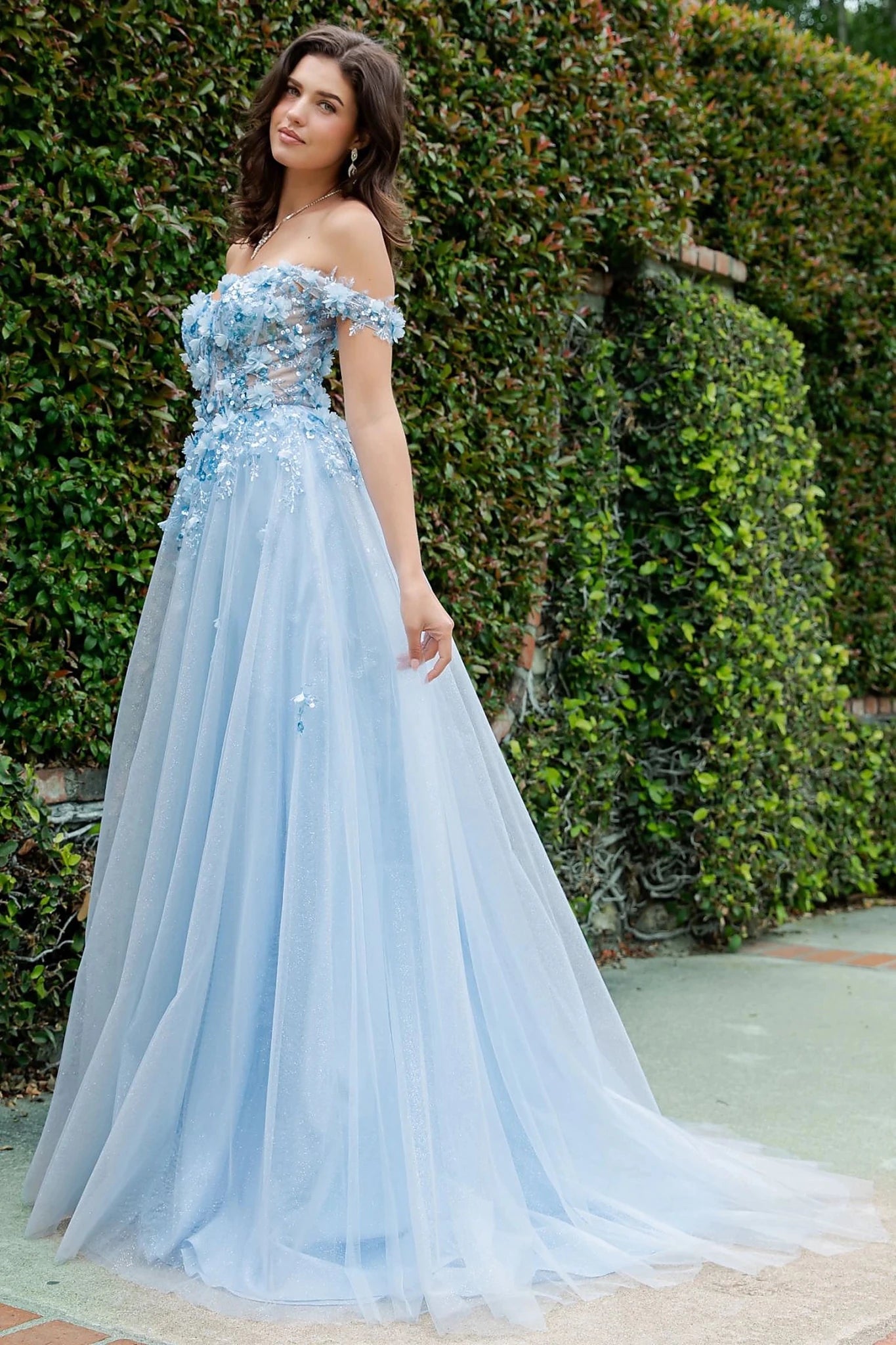 Blue prom dress showcasing voluminous tulle skirt sparkling with light shimmer effect