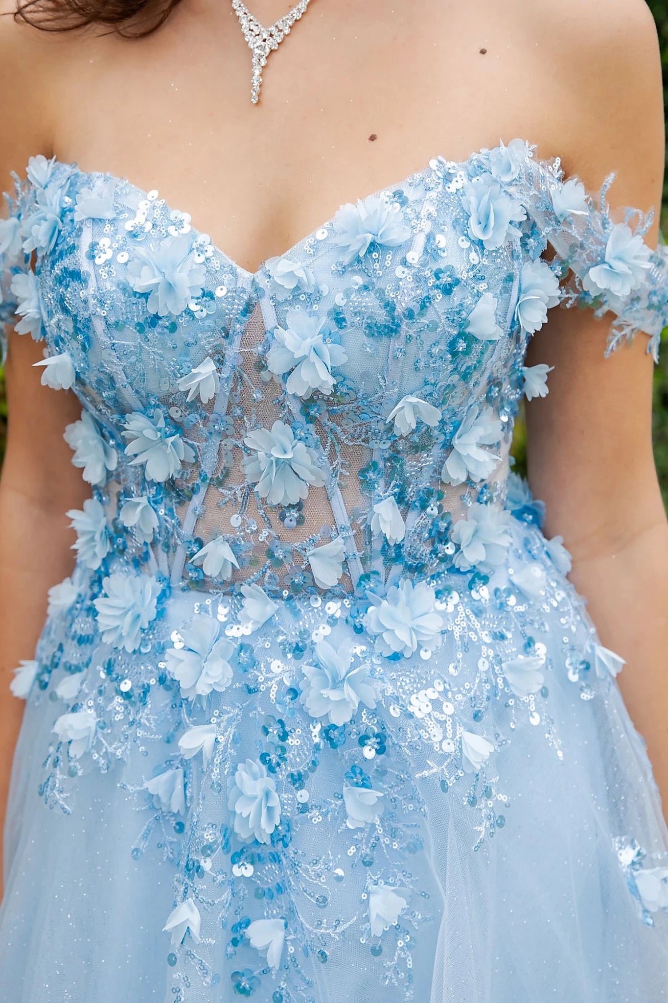 Blue prom dress featuring fitted bodice with lace details and subtle illusion panel