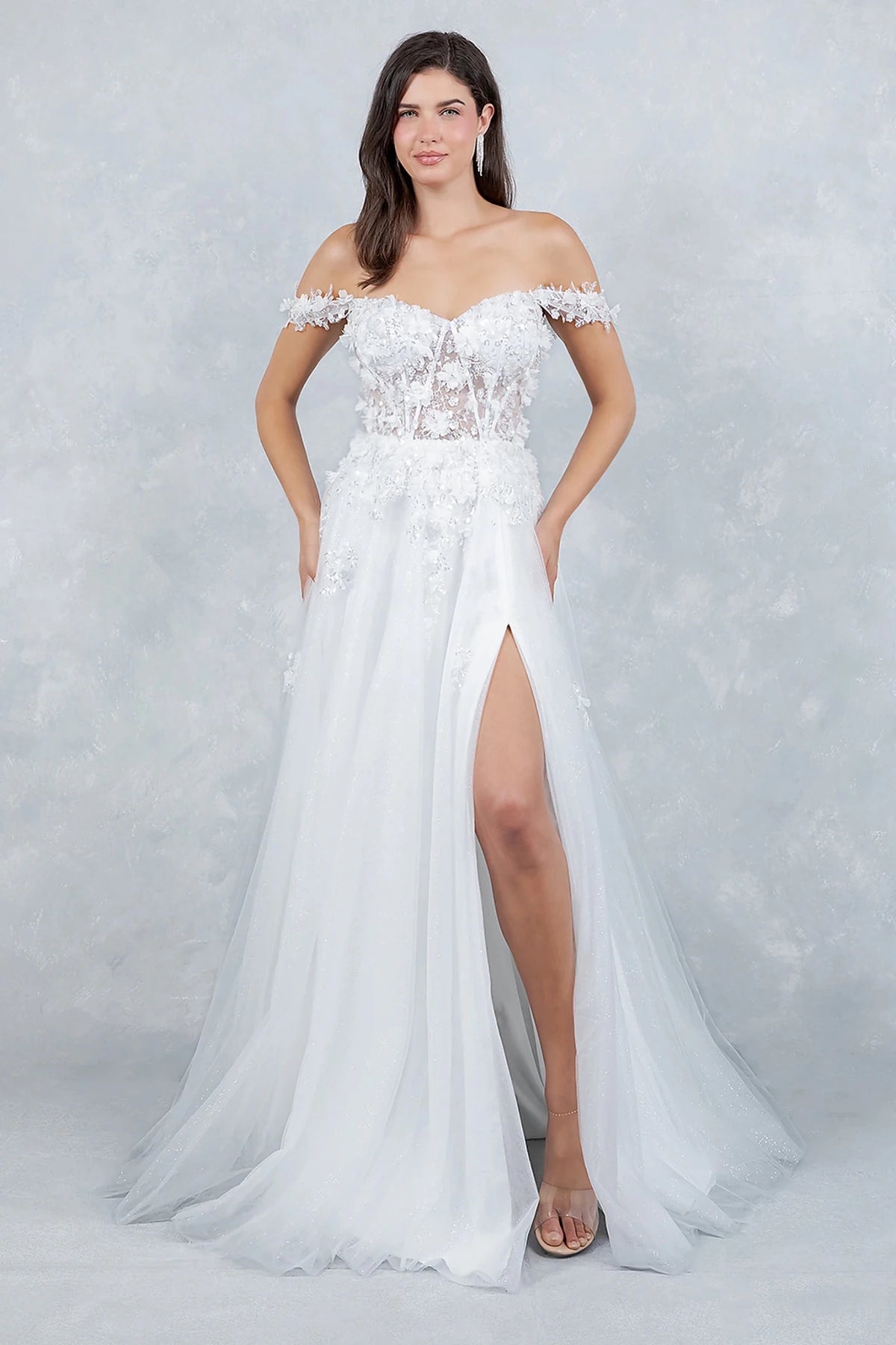 White prom dress designed with front slit adding soft movement to flowing silhouette