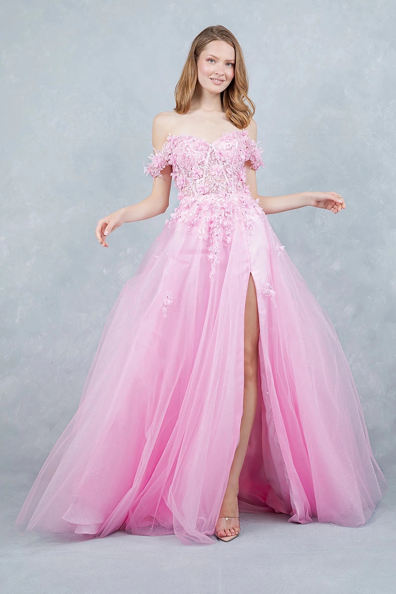 Pink prom dress designed with front slit adding soft movement to flowing silhouette