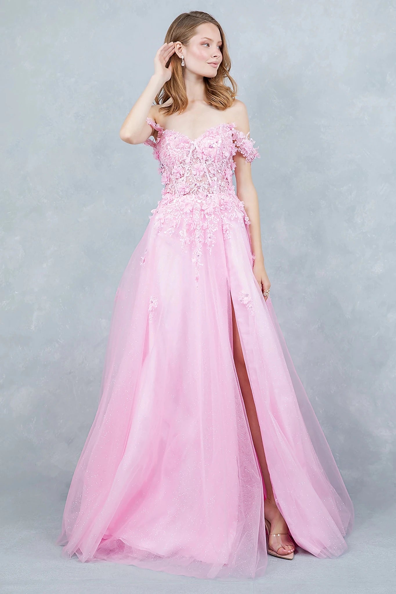 Pink prom dress with off-shoulder neckline adorned in 3D floral appliqués and sequins