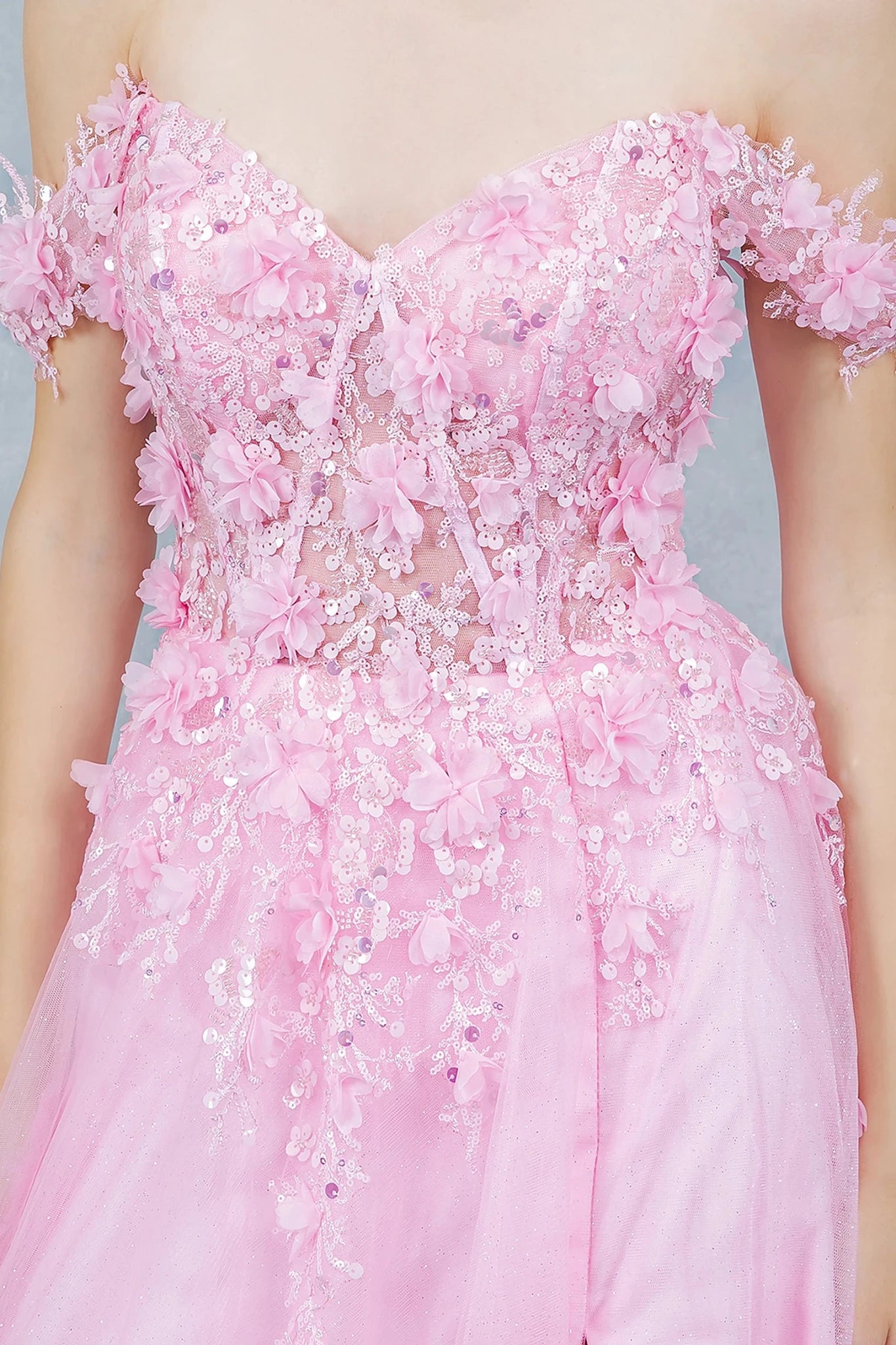 Pink prom dress featuring fitted bodice with lace details and subtle illusion panel with floral appliques