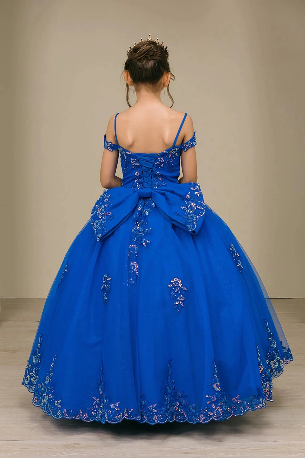 Back full-length view of Royal mini quince off shoulder mini quince dress with embroidered bodice, gemstone accent, glitter tulle skirt, lace up back, and oversized boW.