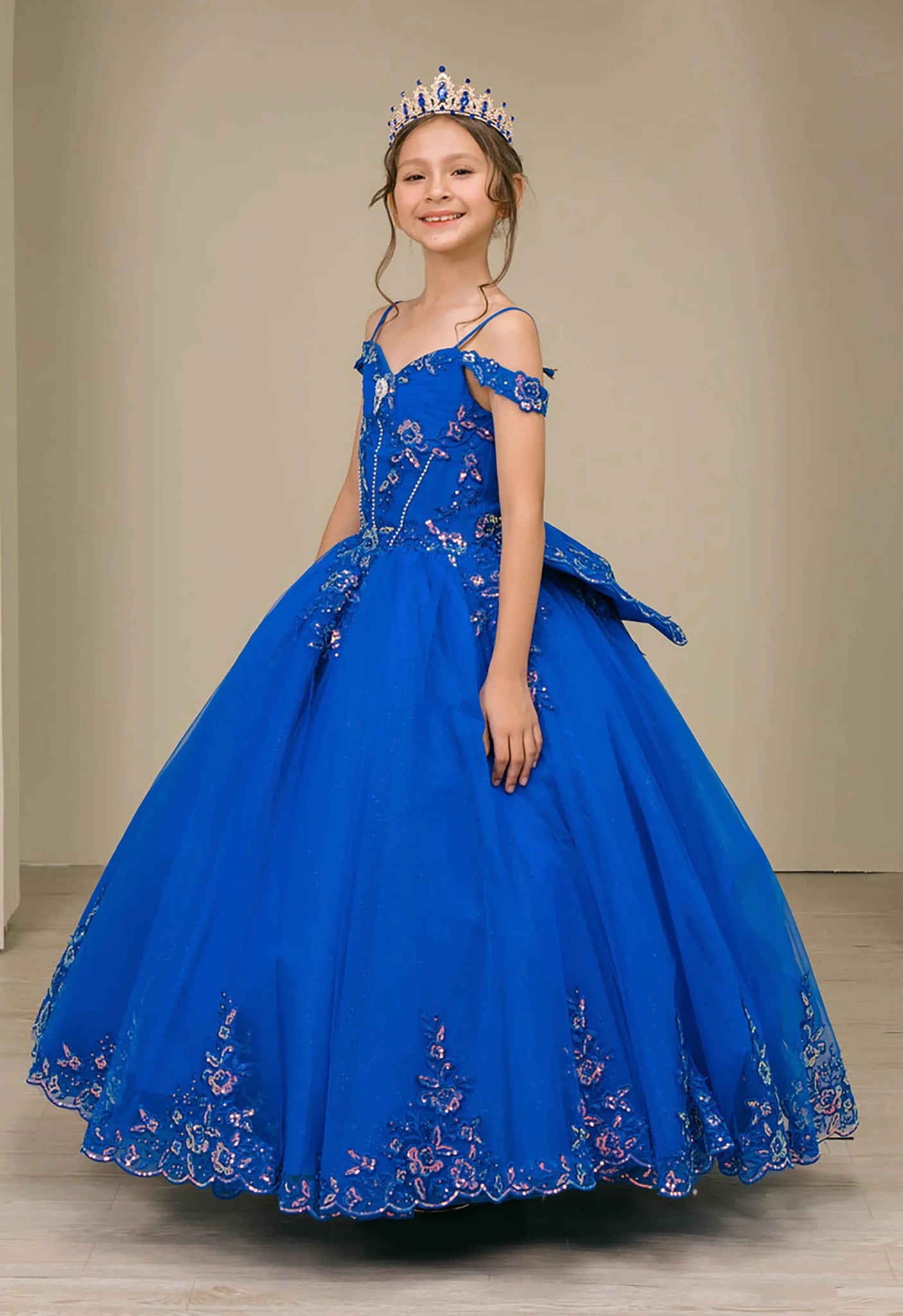 Side full-length view of Royal mini quince off shoulder mini quince dress with embroidered bodice, gemstone accent, glitter tulle skirt, lace up back, and oversized bow.