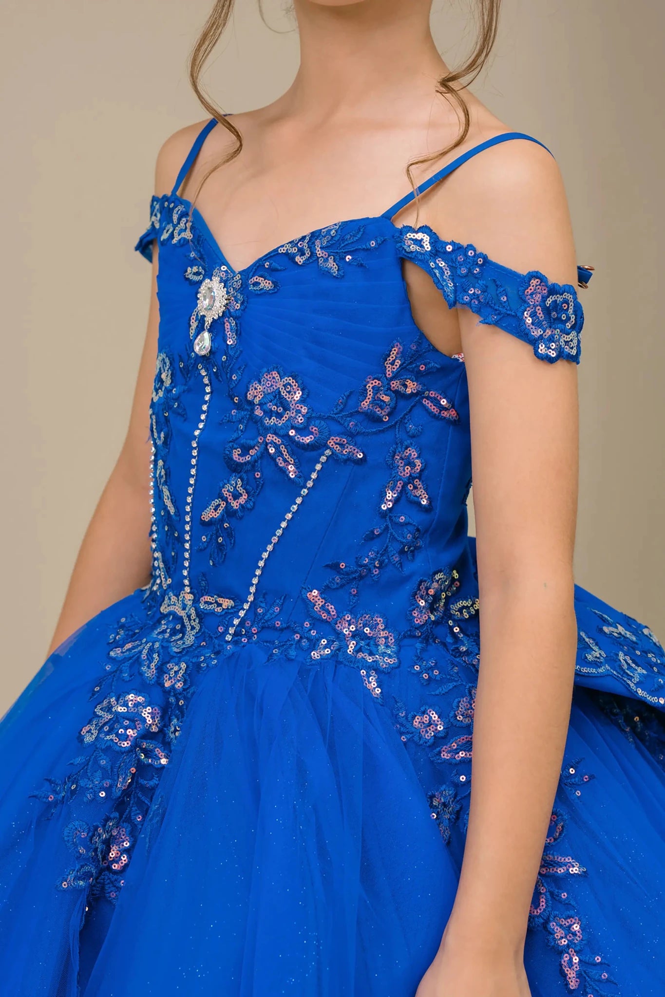 Side close-up Royal mini quince off shoulder mini quince dress with embroidered bodice, gemstone accent, glitter tulle skirt.