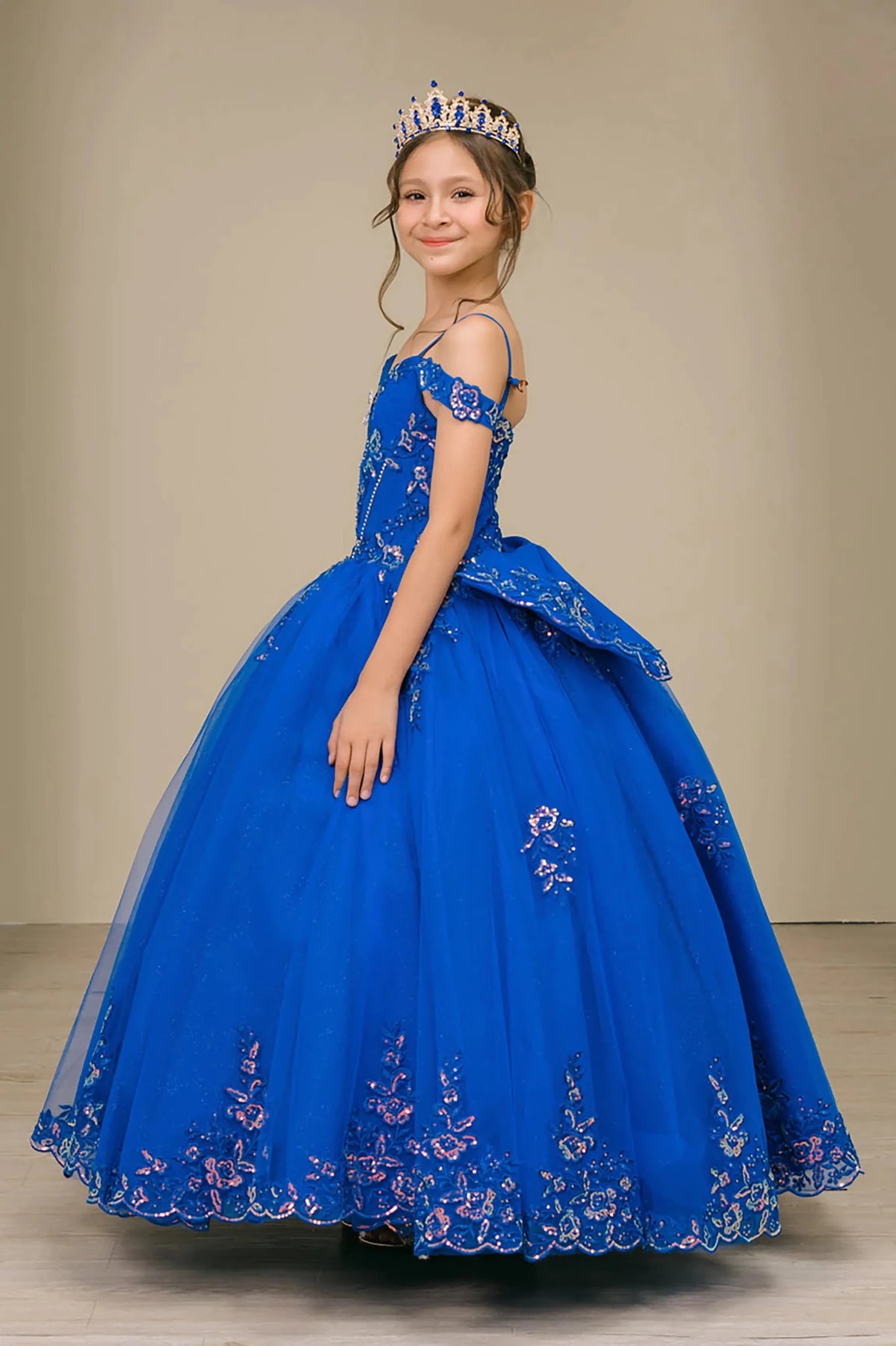 Side full-length view of Royal mini quince off shoulder mini quince dress with embroidered bodice, gemstone accent, glitter tulle skirt, lace up back, and oversized bow.