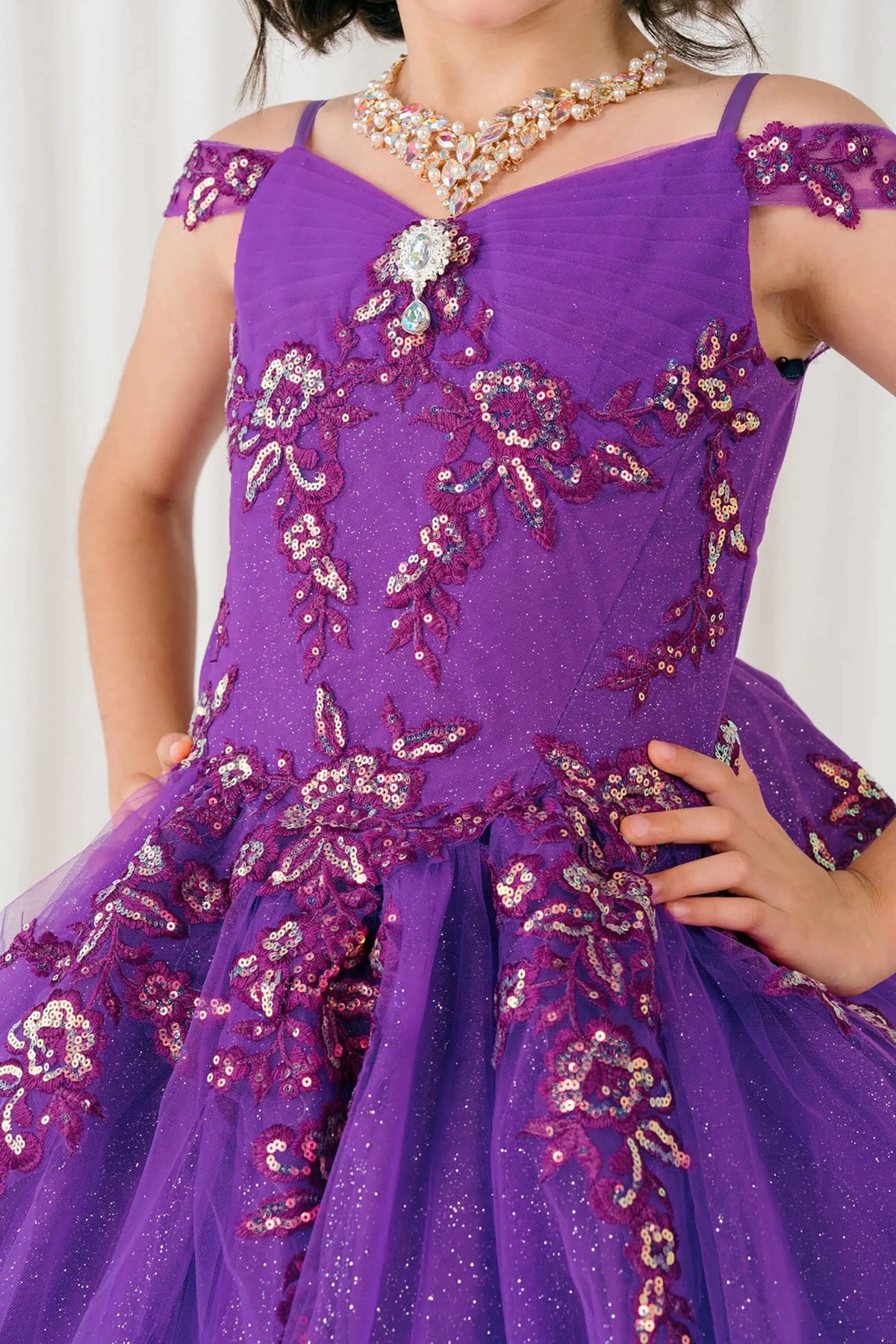 Front close-up Magenta Rose mini quince off shoulder mini quince dress with embroidered bodice, gemstone accent.