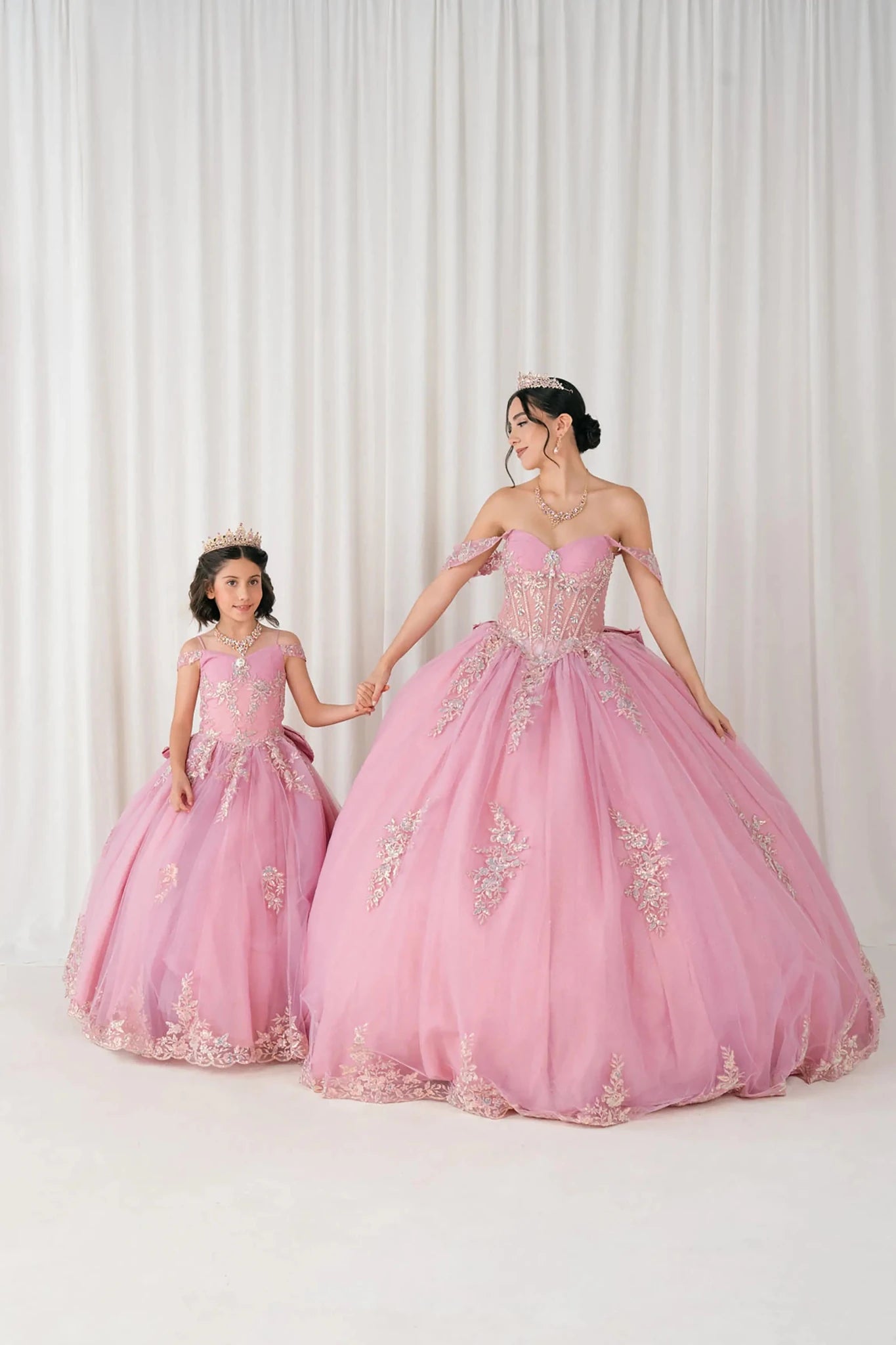 Dusty Rose Off shoulder quinceañera and mini quinceañera ball gown with beaded corset, floral appliqués, layered tulle skirt, cathedral length train, and bow