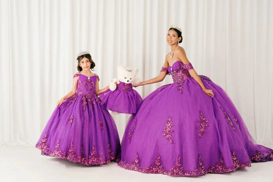 Magenta Off shoulder quinceañera and mini quinceañera ball gown with beaded corset, floral appliqués, layered tulle skirt, cathedral length train, and bow