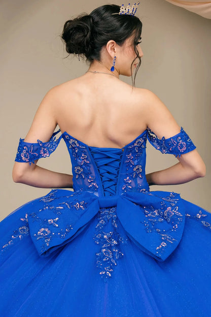 Back half close-up view of Royal Off shoulder quinceañera ball gown with beaded corset, floral appliqués, layered tulle skirt, cathedral length train, and bow