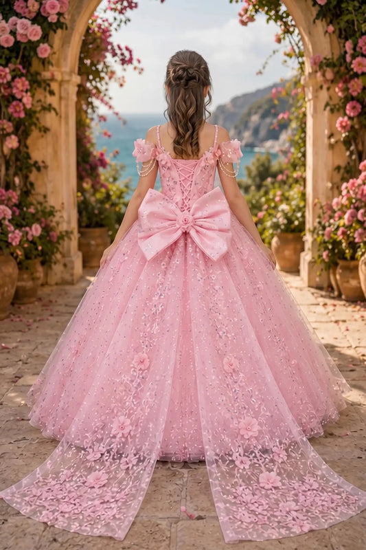 Back view of a pink kids quinceañera dress with layered glitter tulle skirt, lace-up corset closure, and 3D floral accents