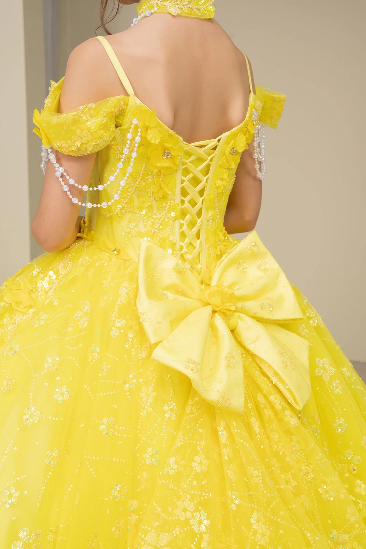 Yellow front view kids mini quinceañera mini quince dress with floral lace, bow detail and glitter tulle skirt.