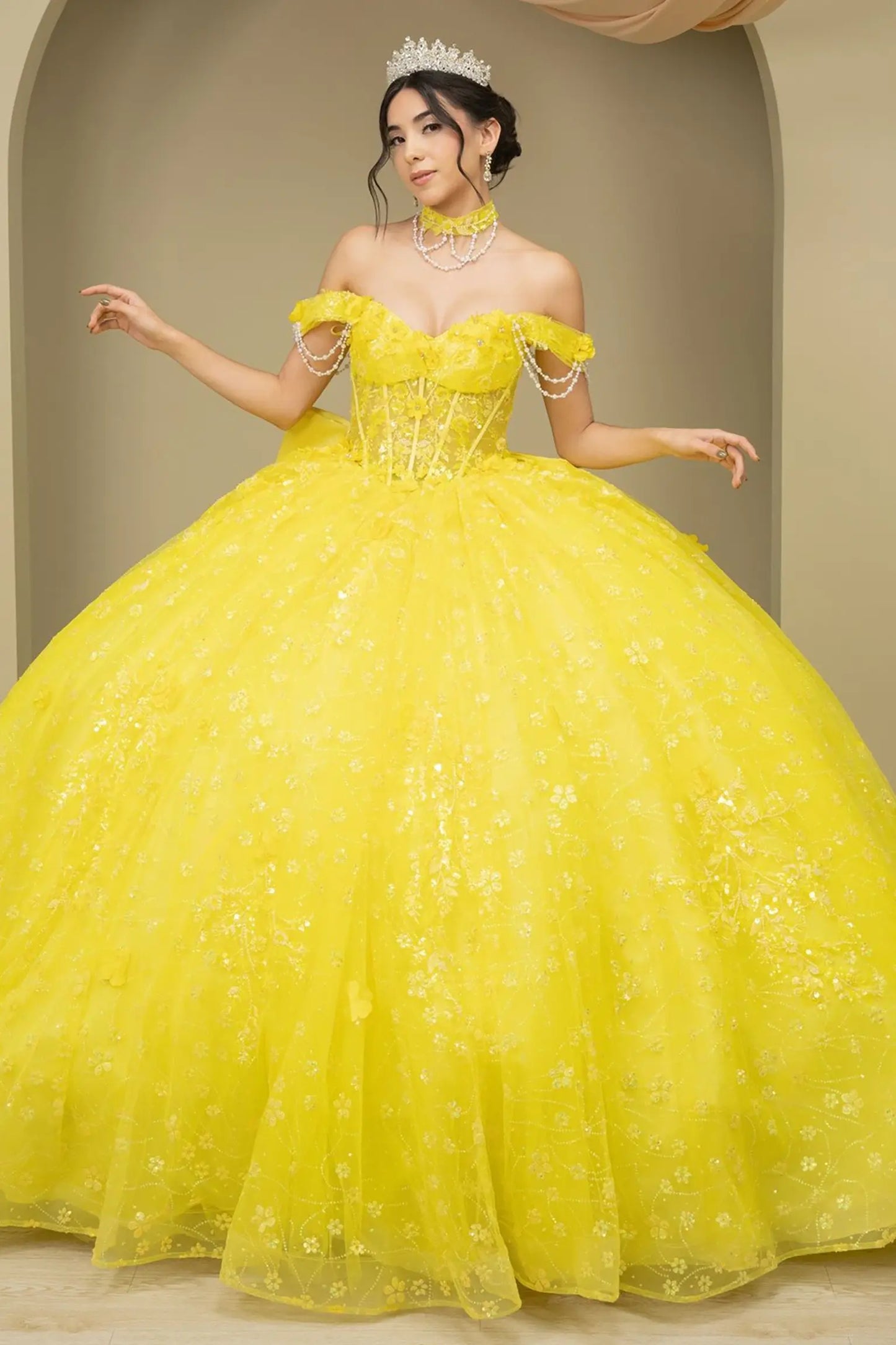 Full front view of a woman wearing yellow quinceañera dress with glitter tulle skirt, off-shoulder sweetheart neckline, and beaded corset bodice.