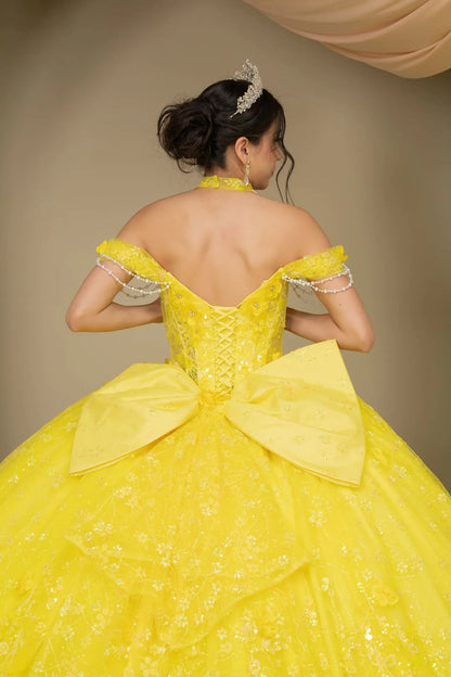 Back close-up view of a woman wearing yellow quinceañera dress highlighting layered glitter tulle, sweetheart neckline, and embellished bodice.