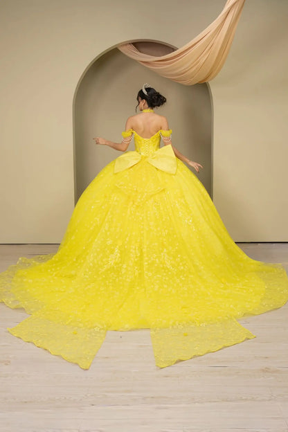 Full back view of a woman wearing yellow quinceañera dress with glitter tulle skirt, off-shoulder sweetheart neckline, and beaded corset bodice.