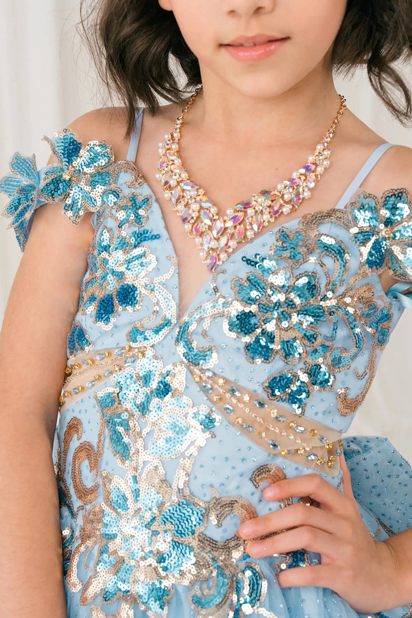 Front Close Up Blue mini quince mini quince dress with off shoulder floral embroidered bodice, glitter tulle.