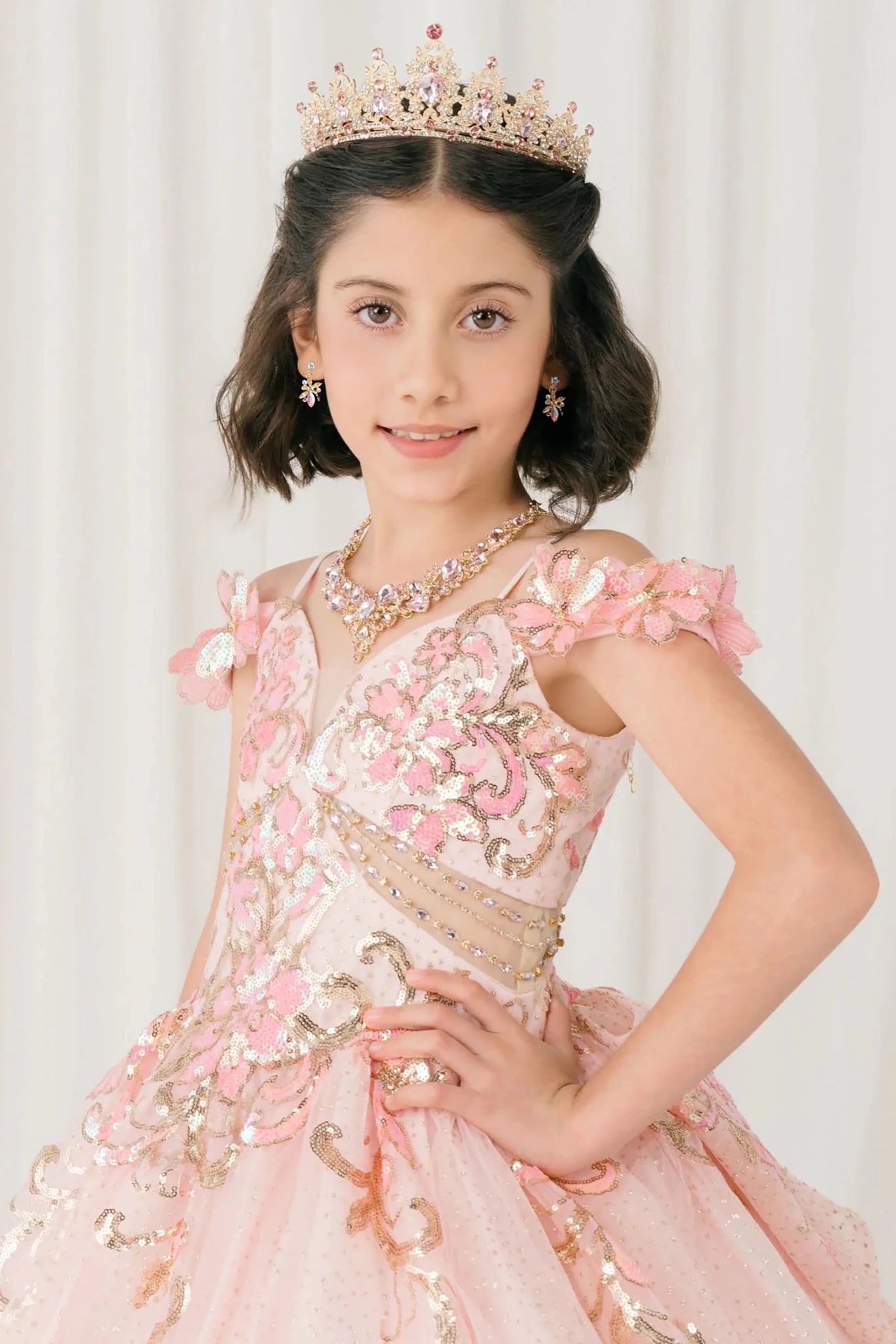 Front close up view of Pink mini quince mini quince dress with off shoulder floral embroidered bodice, glitter tulle.